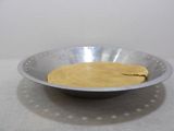 a metal bowl that has some food inside of it