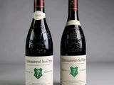 two bottles of wine sitting next to each other on top of a table