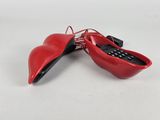 pair of red shoes with a cell phone in the shape of a heart