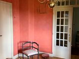 a room with a chair and a chandelier in it