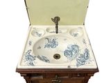 a small sink with a wooden cabinet underneath it