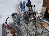 many bikes that are sitting on the floor in the room