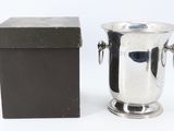 a silver wine cooler and a black box on a white background