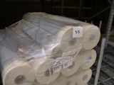 several rolls of toilet paper are stacked on a pallet in a warehouse