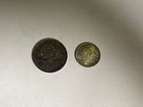 two coins that are sitting next to each other on a table