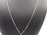 a silver necklace with a white pearl pendant on a mannequin
