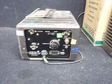a small machine that is sitting next to a box
