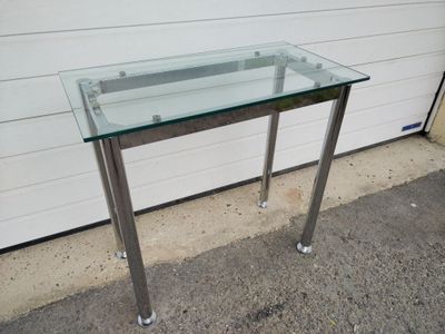 a glass table with a metal frame on it