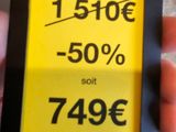 a person holding a cell phone with a price tag on it