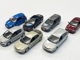 several toy cars are lined up in a row on a white surface