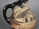 a black and white vase with a painting on it