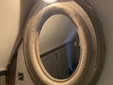 a mirror on the wall above a fireplace in a room