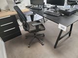 a desk with two computers and a keyboard on it