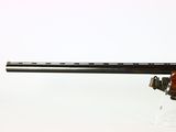 a close up of a rifle on a white surface with a white background