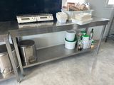 a kitchen with a stainless steel table and a stove