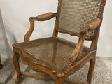 an old wooden chair with a cane back and a cane seat