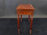 a small wooden table with a drawer on top of it