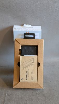 a cardboard box with a cell phone inside of it
