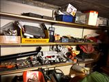 a shelf full of assorted items in a garage