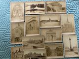 a lot of old photos of buildings on the bed