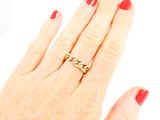 an image of a woman ' s hand with a red manicure and a gold ring