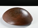 a brown object sitting on a white surface