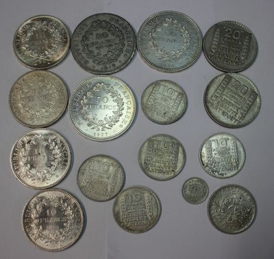 several different types of coins are arranged in a circle on a white surface