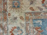 a close up of a blue and orange rug with a floral design
