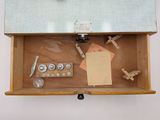 a wooden box with various items in it on a table