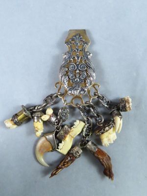 a picture of a brooch with a lot of charms on it