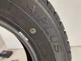 a close up of a tire on a white surface with tools