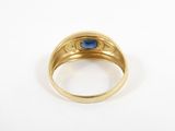 a gold ring with a blue stone in the center