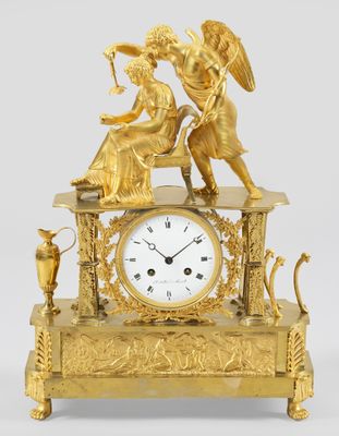 an image of a gold clock with an angel on top of it