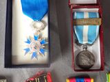 a box with a medal, a medal, a medal, and a medal on it