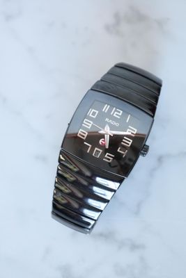a close up of a watch on a marble surface