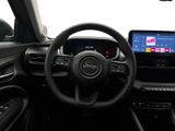 the interior of a car with a steering wheel, dashboard, and a touch screen