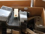 a cardboard box filled with assorted metal items