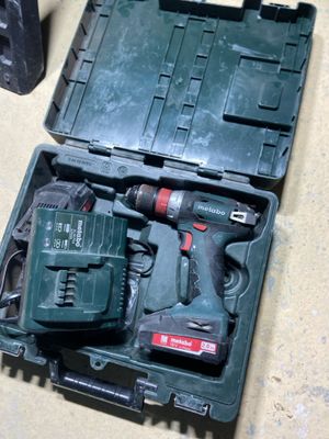 a tool kit in a case on the floor next to a speaker