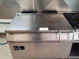 a stainless steel stove and oven in a commercial kitchen