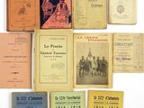 several old books sitting on top of each other on a white surface