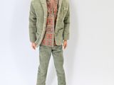 a doll that is wearing a jacket and pants