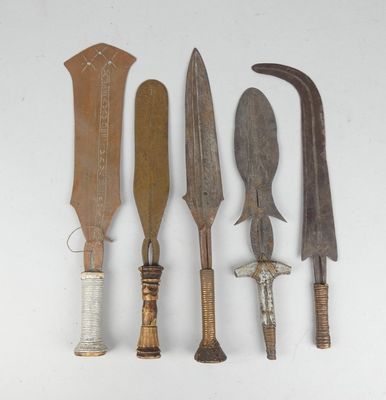 several different types of knives are lined up on a white surface
