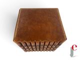 an image of a brown leather book case sitting on top of a white surface
