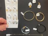 a person holding a piece of jewelry in their hand