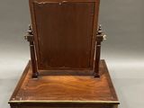 an old wooden desk with a mirror on top of it