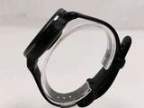 a close up of a watch on a clear stand