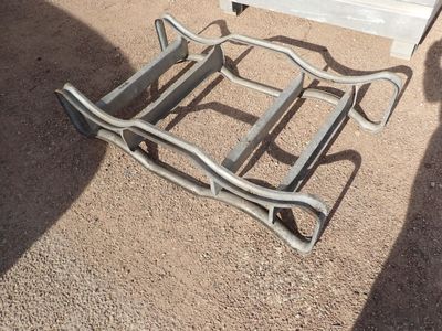 a chair that is sitting on the ground in front of a bench