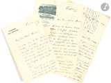several old letters are stacked on top of each other on a white surface