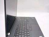 a laptop with a black keyboard sitting on a white surface