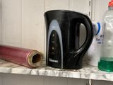 a shelf that has a cup, a mug, and other items on it